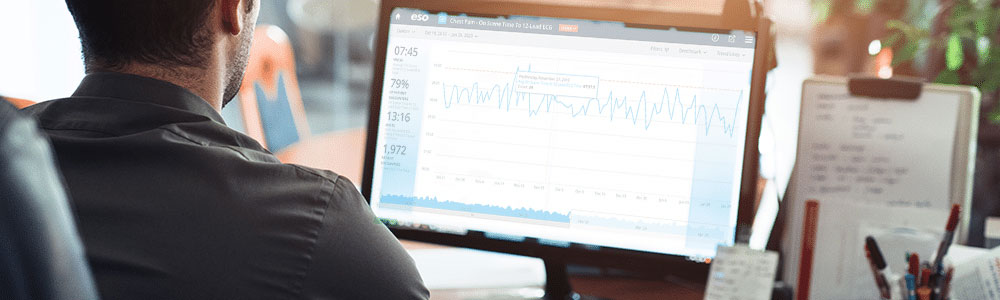 man seated at desktop computer viewing ESO tracking analytics