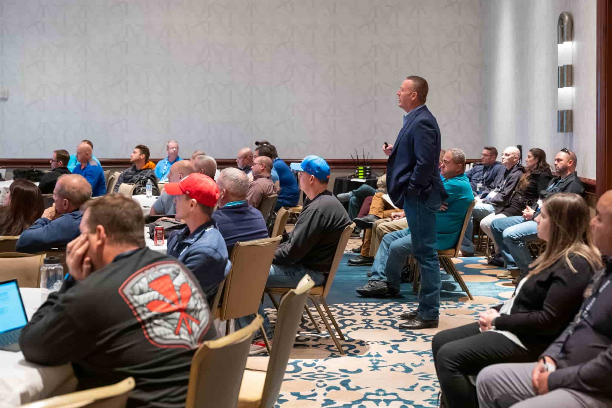 A man standing in a crowd of people giving a lecture at ESO Wave.