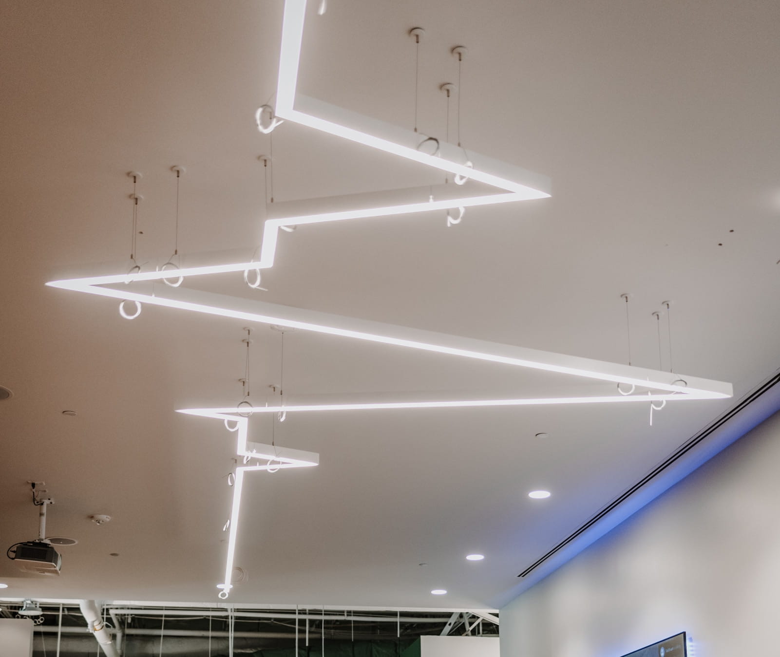 A EKG-shaped light fixture on the ceiling of an office.