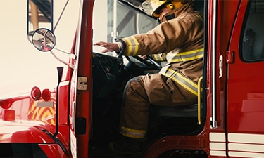 firefighter closing firetruck door