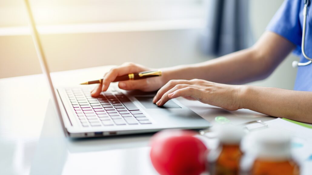 healthcare professional at computer